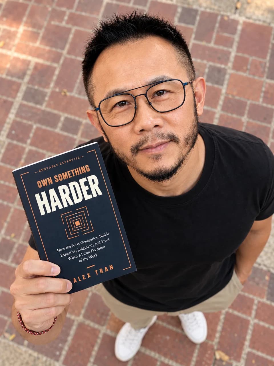 Alex Tran holding Own Something Harder